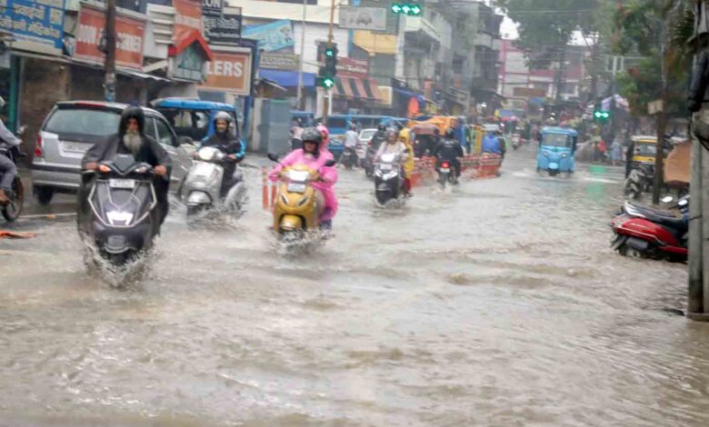 Vehicles pass through a waterlogged stretch of the road at GDMC Hospital Chowk on a rainy day in Dehradun