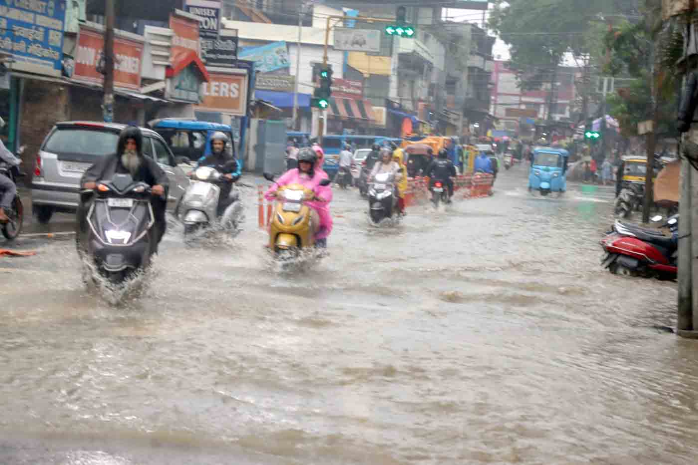 Vehicles pass through a waterlogged stretch of the road at GDMC Hospital Chowk on a rainy day in Dehradun